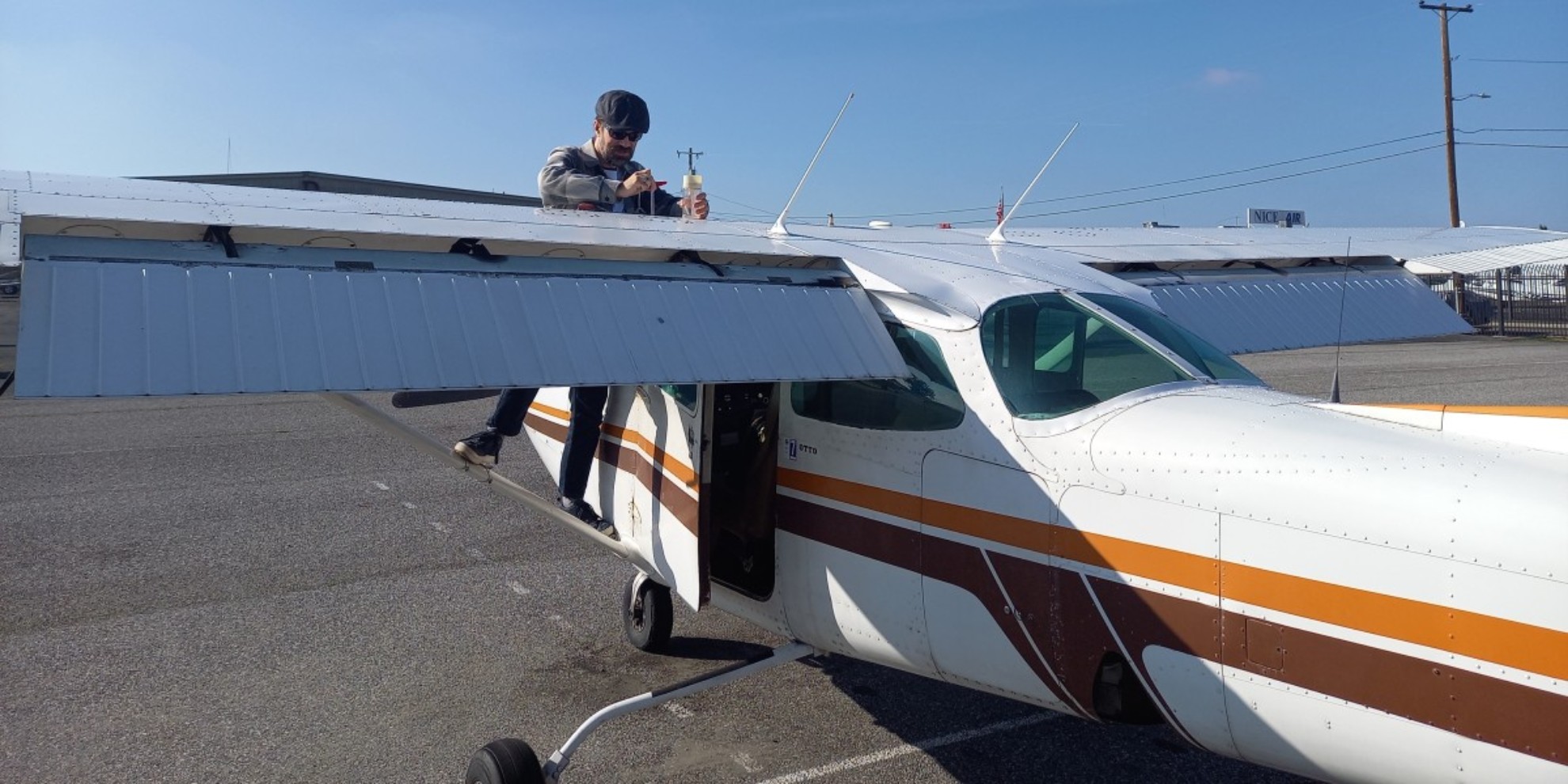 Photo of the author inspecting a small plane prior to flight